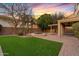 Wide angle shot of backyard features green grass, pool, spa, and covered outdoor patio at 2670 E Parkview Dr, Gilbert, AZ 85295