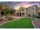 Expansive backyard featuring lush green lawn, mature landscaping, a pool and spa with covered patio at 2670 E Parkview Dr, Gilbert, AZ 85295