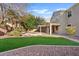 Expansive backyard with green lawn, covered patio, and relaxing pool and spa area at 2670 E Parkview Dr, Gilbert, AZ 85295