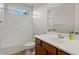 Well-lit bathroom featuring a tub and shower combo, with a vanity and sink at 2670 E Parkview Dr, Gilbert, AZ 85295
