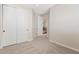 Bedroom featuring carpet and closet with sliding doors, leading to hallway at 2670 E Parkview Dr, Gilbert, AZ 85295