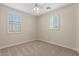 Cozy bedroom with carpet, ceiling fan, and windows with shutters for natural light at 2670 E Parkview Dr, Gilbert, AZ 85295