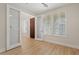 Bright bedroom with hardwood floors, sliding glass doors, and three windows with plantation shutters at 2670 E Parkview Dr, Gilbert, AZ 85295
