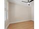 Bedroom with hardwood floors, baseboards, and a window with plantation shutters at 2670 E Parkview Dr, Gilbert, AZ 85295