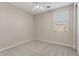 Cozy bedroom featuring carpet, ceiling fan, and natural light from a window at 2670 E Parkview Dr, Gilbert, AZ 85295