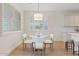 Charming dining area featuring a round glass table, plush chairs, and an elegant pendant light fixture at 2670 E Parkview Dr, Gilbert, AZ 85295