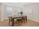 Bright dining room with wood floors, plantation shutters, and an elegant chandelier at 2670 E Parkview Dr, Gilbert, AZ 85295