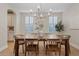 Bright dining room with wood floors, plantation shutters, and an elegant chandelier at 2670 E Parkview Dr, Gilbert, AZ 85295