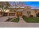 Charming two-story home featuring a landscaped front yard and a two-car garage with brick accents at 2670 E Parkview Dr, Gilbert, AZ 85295