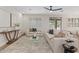 Bright living room featuring neutral décor, plantation shutters, and sliding glass doors to the outdoor space at 2670 E Parkview Dr, Gilbert, AZ 85295