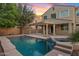 Backyard pool with attached spa and covered patio, perfect for outdoor entertaining at 2670 E Parkview Dr, Gilbert, AZ 85295