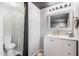 Bathroom featuring a shower with a patterned curtain, white vanity, and a decorative mirror at 2700 E Allred Ave # A3, Mesa, AZ 85204