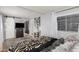 Bedroom showcasing a zebra-striped comforter with black accents, a TV on a dresser, and a sunlit window at 2700 E Allred Ave # A3, Mesa, AZ 85204