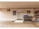 Covered parking area or carport with a white door, windows, and storage; functional and practical space at 2700 E Allred Ave # A3, Mesa, AZ 85204