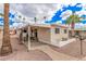 Attractive single-story home with a carport, landscaped yard, and mature palm trees in a vibrant community at 2700 E Allred Ave # A3, Mesa, AZ 85204