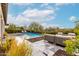 Inviting backyard with a pool, comfortable seating area, and lush landscaping, perfect for relaxation and entertaining at 29606 N Tarragona Dr, Peoria, AZ 85383
