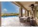Covered patio with outdoor dining area, overlooking a pool and scenic backyard at 29606 N Tarragona Dr, Peoria, AZ 85383