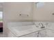 Serene bathroom with marble lined soaking tub featuring updated faucet hardware at 29606 N Tarragona Dr, Peoria, AZ 85383