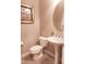 Powder room with pedestal sink, oval mirror, framed art and neutral paint scheme at 29606 N Tarragona Dr, Peoria, AZ 85383