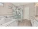 Elegant bathroom featuring a soaking tub, glass enclosed shower, and granite countertops at 29606 N Tarragona Dr, Peoria, AZ 85383