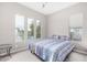 Bright bedroom with carpet, large windows, and a queen-sized bed adorned with a colorful patterned quilt at 29606 N Tarragona Dr, Peoria, AZ 85383