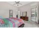 Bright bedroom featuring a modern dresser, and doorway to en-suite bathroom at 29606 N Tarragona Dr, Peoria, AZ 85383