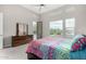 Stylish bedroom with views of the pool, a ceiling fan and a modern dresser at 29606 N Tarragona Dr, Peoria, AZ 85383
