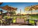 Outdoor bocce ball court with inviting seating under shaded umbrellas at 29606 N Tarragona Dr, Peoria, AZ 85383