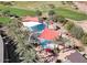 Aerial view of a large community pool with sunshades, lounge chairs, and palm trees at 29606 N Tarragona Dr, Peoria, AZ 85383