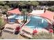 Aerial view of a community pool featuring sunshades, lounge chairs, and palm trees at 29606 N Tarragona Dr, Peoria, AZ 85383