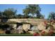 Landscaped entrance sign featuring stacked stone and a cascading waterfall at 29606 N Tarragona Dr, Peoria, AZ 85383