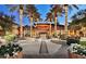Stunning exterior view of a building surrounded by palm trees with elegant outdoor seating and lighting at 29606 N Tarragona Dr, Peoria, AZ 85383