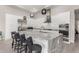 Bright modern kitchen with white cabinets, stainless steel appliances and a large island with seating at 29606 N Tarragona Dr, Peoria, AZ 85383