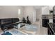 Open concept living area with kitchen, laminate floors, contemporary furniture, and ample space at 29606 N Tarragona Dr, Peoria, AZ 85383