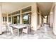 Outdoor patio area includes a dining table with seating, a ceiling, and views of the pool and backyard at 29606 N Tarragona Dr, Peoria, AZ 85383
