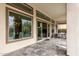 Covered patio area with tiled flooring, outdoor dining set, and seamless indoor-outdoor living at 29606 N Tarragona Dr, Peoria, AZ 85383