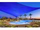 Inviting pool area with lounge chairs and palm trees against a sunset backdrop at 29606 N Tarragona Dr, Peoria, AZ 85383