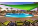 Enjoy this beautiful pool with ample seating, shade, and palm trees surrounding the area at 29606 N Tarragona Dr, Peoria, AZ 85383