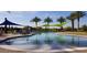 A stunning pool with shade sails, palm trees and plenty of room for swimming and relaxing at 29606 N Tarragona Dr, Peoria, AZ 85383