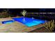 Relaxing night view of the backyard pool with an inset hot tub and accent lighting at 29606 N Tarragona Dr, Peoria, AZ 85383