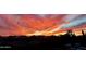 Scenic dusk panorama of fiery red clouds over neighborhood homes at 29606 N Tarragona Dr, Peoria, AZ 85383