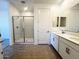 Bright bathroom with a glass shower, double sinks, and tile flooring at 32723 N Newby Dr, San Tan Valley, AZ 85140