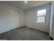 Bedroom featuring neutral carpet, closet with sliding doors, and a window for natural light at 32723 N Newby Dr, San Tan Valley, AZ 85140