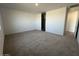 Spacious carpeted bedroom with ensuite bath access bathed in soft, natural light at 32723 N Newby Dr, San Tan Valley, AZ 85140