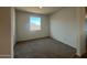 A clean bedroom with carpet, a large window, and ample sunlight at 32723 N Newby Dr, San Tan Valley, AZ 85140