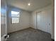 Bedroom with neutral carpet, closet with sliding doors, and a window for natural light at 32723 N Newby Dr, San Tan Valley, AZ 85140
