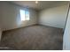 Expansive carpeted bedroom with a large window offering natural light at 32723 N Newby Dr, San Tan Valley, AZ 85140