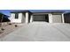 A single-story home with a large driveway and two-car garage provides ample parking at 32723 N Newby Dr, San Tan Valley, AZ 85140
