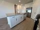 Bright kitchen features an island, stainless steel appliances, and white cabinets at 32723 N Newby Dr, San Tan Valley, AZ 85140