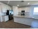 A modern kitchen featuring white cabinets, stainless steel appliances, and a large island at 32723 N Newby Dr, San Tan Valley, AZ 85140